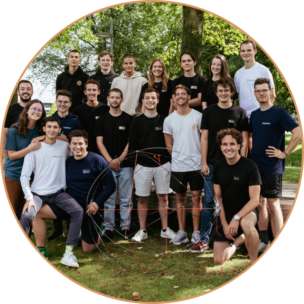 A group image of Team Tumbleweed members surrounding a prototype structure of the Tumbleweed Mars rover.